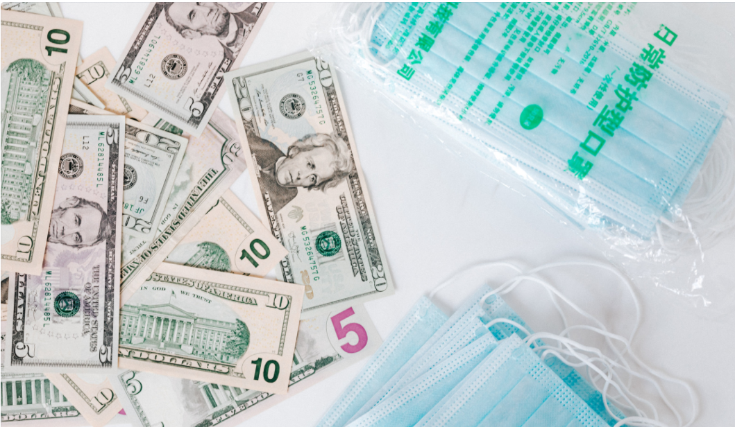 Surgical mask and stack of cash